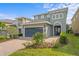 Charming home with a two-car garage and a lovely brick paved driveway, surrounded by mature landscaping at 441 Novi Path, Kissimmee, FL 34747