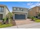 Charming home with a two-car garage and a lovely brick paved driveway, surrounded by mature landscaping at 441 Novi Path, Kissimmee, FL 34747
