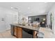 Spacious kitchen island with a sink and dishwasher, flowing into an open-concept living area at 441 Novi Path, Kissimmee, FL 34747