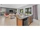Open floor plan featuring a large island with a sink, and a seamless transition to the living area at 441 Novi Path, Kissimmee, FL 34747