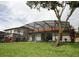Spacious backyard featuring a large screened-in pool and outdoor seating areas at 446 Summer Place Loop, Clermont, FL 34714