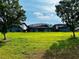 Expansive backyard view featuring a screened-in pool area and mature trees, providing a serene setting at 446 Summer Place Loop, Clermont, FL 34714