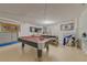 Spacious basement featuring a pool table, foosball table, and laundry area at 446 Summer Place Loop, Clermont, FL 34714