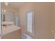 Bathroom with shower and access door leading outside at 446 Summer Place Loop, Clermont, FL 34714