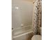 Bathroom with white tiled shower/tub combo and themed shower curtain at 446 Summer Place Loop, Clermont, FL 34714