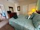 Bright bedroom features a TV, lamps, a closet and a comfortable queen bed at 446 Summer Place Loop, Clermont, FL 34714