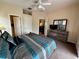This cozy bedroom features a dresser with TV, multiple closets and neutral color scheme at 446 Summer Place Loop, Clermont, FL 34714