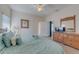 Bright and airy bedroom with a king-size bed and a view into the bathroom at 446 Summer Place Loop, Clermont, FL 34714