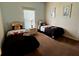 Bright bedroom featuring twin beds with themed decor and a window with blinds at 446 Summer Place Loop, Clermont, FL 34714