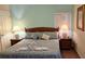 Comfortable bedroom with rattan headboard, matching nightstands and lamps at 446 Summer Place Loop, Clermont, FL 34714