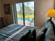 Bright bedroom featuring sliding glass doors that offer a beautiful view of the outdoor swimming pool at 446 Summer Place Loop, Clermont, FL 34714