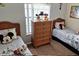 Bedroom with twin beds and a woven dresser at 446 Summer Place Loop, Clermont, FL 34714