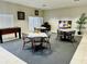 Clubhouse lounge area with tables, chairs, foosball, and television at 446 Summer Place Loop, Clermont, FL 34714