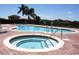 Inviting community pool and jacuzzi area with ample seating and lush landscaping at 446 Summer Place Loop, Clermont, FL 34714