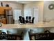The dining room adjacent to the kitchen has a table with black chairs and stainless steel appliances at 446 Summer Place Loop, Clermont, FL 34714