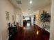 Inviting entryway with gleaming hardwood floors leads to the spacious living area at 446 Summer Place Loop, Clermont, FL 34714