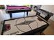 Entertain in this game room, featuring a pool table, air hockey, and foosball for endless fun at 446 Summer Place Loop, Clermont, FL 34714
