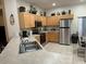 Functional kitchen featuring stainless steel appliances and ample counter space, ideal for cooking enthusiasts at 446 Summer Place Loop, Clermont, FL 34714