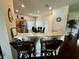 The kitchen has a bar counter with stool seating plus a dining room with stainless steel appliances at 446 Summer Place Loop, Clermont, FL 34714