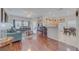 Bright and airy living space connecting the living room and kitchen with hardwood floors at 446 Summer Place Loop, Clermont, FL 34714