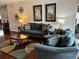 Comfortable living room featuring plush blue sofas and stylish decor at 446 Summer Place Loop, Clermont, FL 34714
