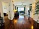 Open-concept living room featuring hardwood floors, large windows, and a welcoming atmosphere at 446 Summer Place Loop, Clermont, FL 34714