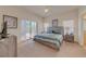 Spacious main bedroom with a king-size bed and a large sliding glass door to the outside patio at 446 Summer Place Loop, Clermont, FL 34714