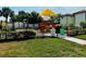 Community playground with slides and play area, perfect for children to enjoy outdoor activities at 446 Summer Place Loop, Clermont, FL 34714