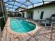 Tranquil screened-in pool area with brick pavers and comfortable lounge chairs, perfect for relaxing poolside at 446 Summer Place Loop, Clermont, FL 34714