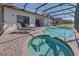 Relaxing pool and spa featuring a brick patio and a screened-in enclosure at 446 Summer Place Loop, Clermont, FL 34714