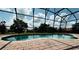 Screened-in pool area features brick patio and view of the community at 446 Summer Place Loop, Clermont, FL 34714