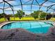 Beautiful screened-in pool area with lush green views, offering privacy and tranquility at 446 Summer Place Loop, Clermont, FL 34714