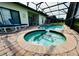 Inviting screened-in pool and spa area with brick pavers; perfect for year-round enjoyment at 446 Summer Place Loop, Clermont, FL 34714
