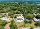 Lovely aerial view of a home featuring a swimming pool, circular driveway, and mature trees at 4674 Hall Rd, Orlando, FL 32817