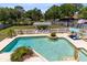 An aerial view of an inviting pool with a pergola seating area, lounge chairs, and a spa at 4674 Hall Rd, Orlando, FL 32817
