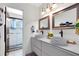 Bathroom featuring double sinks, modern fixtures, and a separate shower room at 4674 Hall Rd, Orlando, FL 32817