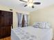 Cozy bedroom with warm lighting, hardwood floors, and a white metal frame bed at 4674 Hall Rd, Orlando, FL 32817