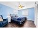 Comfortable bedroom with a ceiling fan, wood floors, and soothing blue walls and decor at 4674 Hall Rd, Orlando, FL 32817