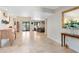 Elegant foyer with travertine floors, a decorative mirror, and views into the living areas at 4674 Hall Rd, Orlando, FL 32817