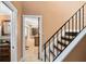 Hallway view with tile flooring, leading to an adjacent bathroom and kitchen area with wooden cabinets at 4674 Hall Rd, Orlando, FL 32817