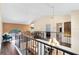 Upstairs landing with hardwood floors, wrought iron railing, and bright sitting area with an arched window at 4674 Hall Rd, Orlando, FL 32817