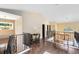 Upstairs landing with hardwood floors, decorative railing, and charming bench seating area near an arched window at 4674 Hall Rd, Orlando, FL 32817