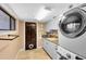A laundry room with a washer, dryer, utility sink and storage space at 4674 Hall Rd, Orlando, FL 32817