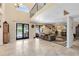 Open living area featuring travertine floors, high ceilings, and access to the outdoor pool area at 4674 Hall Rd, Orlando, FL 32817