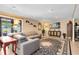 A living room with a large sectional sofa, TV, and access to the outside at 4674 Hall Rd, Orlando, FL 32817