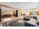 A large living room with a fireplace, sectional sofa, and access to the kitchen at 4674 Hall Rd, Orlando, FL 32817