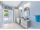 Bright main bathroom features a double sink vanity, modern mirrors, and access to the outdoor patio area at 4674 Hall Rd, Orlando, FL 32817