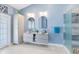 Bright main bathroom featuring a double sink vanity, modern mirrors, and a glass-enclosed shower with modern fixtures at 4674 Hall Rd, Orlando, FL 32817