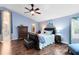 Comfortable main bedroom featuring hardwood floors, a ceiling fan, and access to a walk-in closet and bathroom at 4674 Hall Rd, Orlando, FL 32817