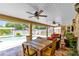 A covered patio with outdoor seating, fans, and views of the pool at 4674 Hall Rd, Orlando, FL 32817